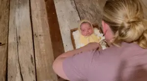 Jackie at her photography studio in Cincinnati posing a newborn as part of her photoshoot process